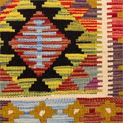 Afghan Maimana flatweave kilim, central field features large bold nested diamond motifs and stylized geometric lozenge patterns on olive purple, blue, and green tone ground, border stripe in mustard ground, and fringe