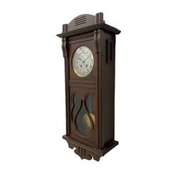 An early 20th century Art nouveau style wall clock with a French countwheel movement by Japy Freres, Paris, in an oak case with a shaped pediment, reeded mouldings and glazed panels, 7” silvered dial with a gilt slip and continental 24-hour Arabic numerals, minute track and steel spade hands, visible pendulum with a brass bob beneath, eight-day spring driven striking movement striking the hours and half-hours on a single gong rod. Movement and dial both stamped with the Japy Feres trademark.




