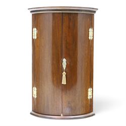 Small Georgian mahogany cylindrical hanging corner cabinet, projecting cornice with dentil...
