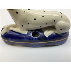 Collection of Staffordshire pottery, comprising pair of pen holders, modelled as recumbent greyhounds on blue washed cushion bases, together with a two pairs of seated dogs, one pair modeled as dalmatians and a house