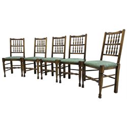 Set of five Lancashire design elm spindle back chairs, shaped cresting rail over two rows of five spindles, upholstered drop-on seats, on turned front supports united by turned stretchers  