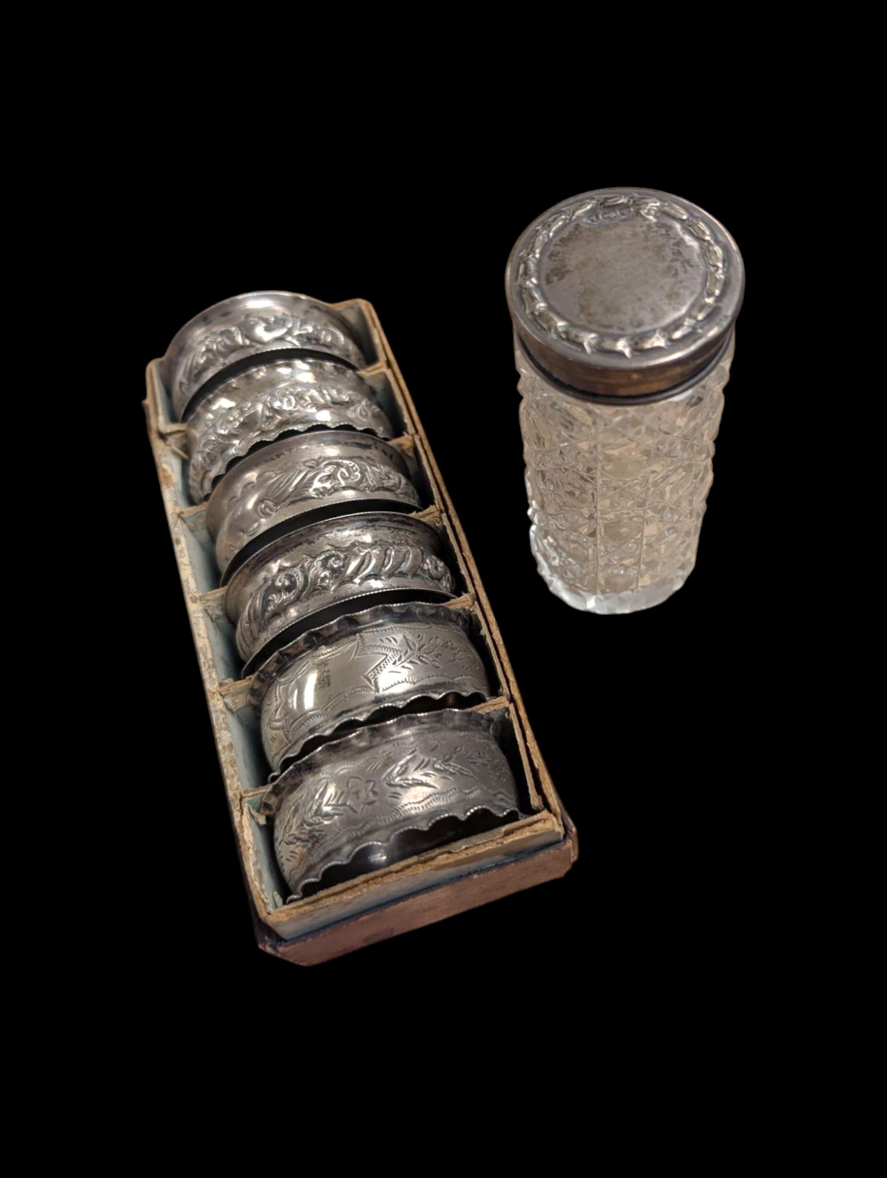 Six silver napkin rings, together with a silver topped cut glass jar, all hallmarked