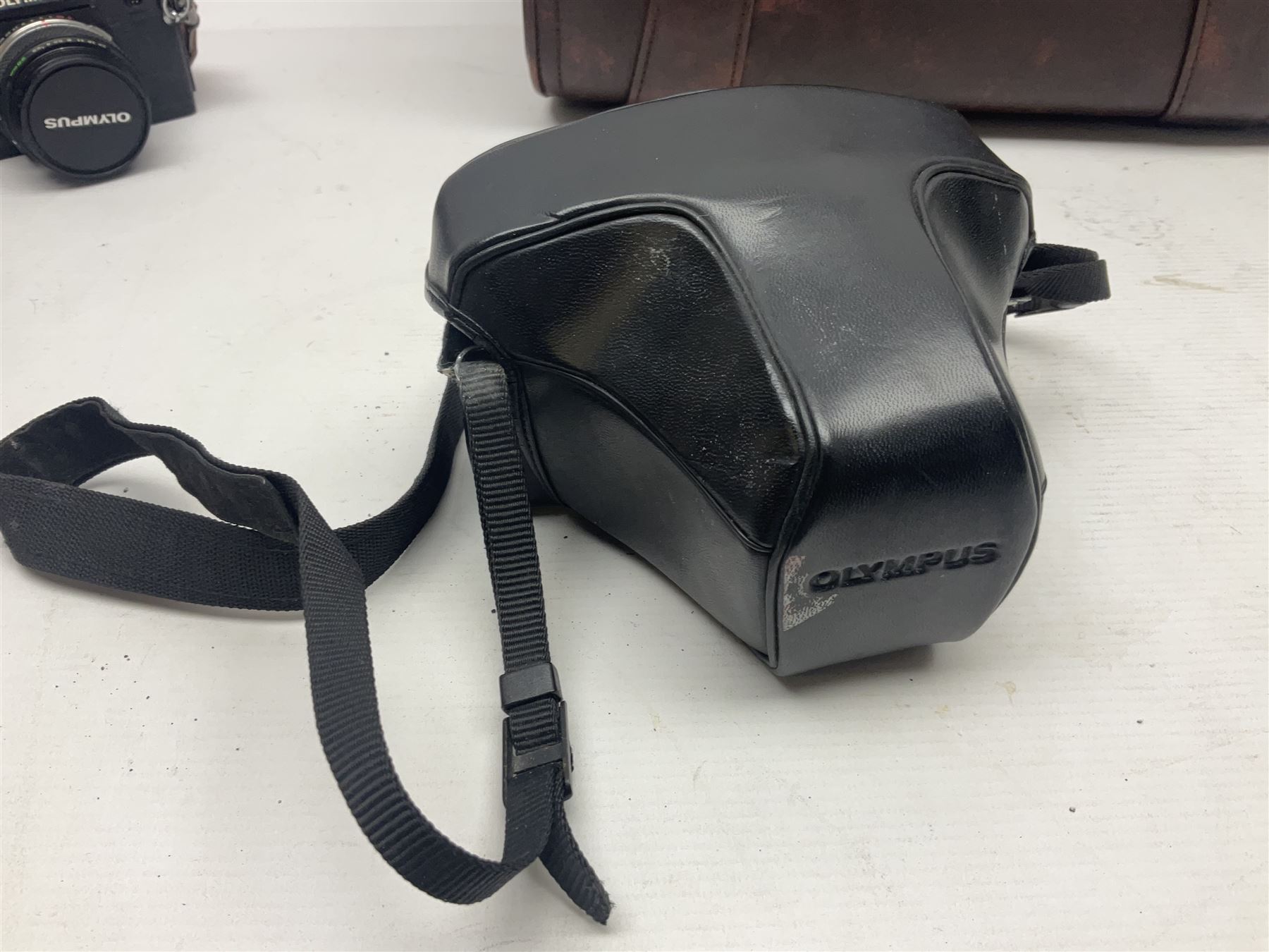 Olympus OM-2 camera body, serial no 1117526, with Olympus OM-System Zuiko Auto-W 28mm 1:2.8'  lens serial no 336591, Olympus OM10 camera body serial no 2392257, with Olympus OM-System Zuiko Auto-Macro 50mm 1:3.5' lens serial no 225784, Soligor C/D mirror lens 1:8 f=500mm' serial no 784035650 together with other camera equipment 