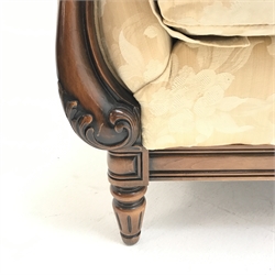Traditional style armchair upholstered in a patterned pale gold fabric, scrolling arms, turned supports, W94cm