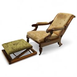 William IV mahogany gentleman's library reclining armchair, leather button upholstered and brass-studded back and seat, above leather-covered arms terminating with carved roundels and foliate scroll-carved ends, underside with brass mechanical trigger reclining lever, the apron with retractable foot rest, supported on lappet carved and turned legs with brass castors, circa 1835