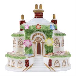 Collection of Coalport items, comprising floral mantel clock, houses including 'Park Lodge' 'The Umbrella House' 'Keepers Cottage', Coalbrookdale floral jar, and others; Kingmaker mouse ornament; Egyptian-style granite Bastet cat ornament, in one box