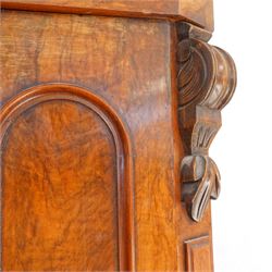Victorian late 19th-century mahogany wardrobe, moulded cornice with rounded corners above arched mirror door, flanked by arched panels and side with carved corbels, on plinth base  