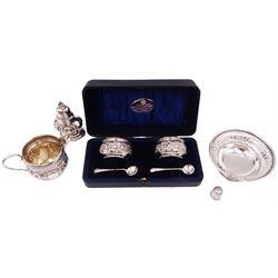Group of silver, comprising pair of Edwardian silver open salts, of circular form, with repousse floral and C scroll decoration, and pair of matching salt spoons, hallmarked Joseph Gloster, Birmingham 1907, in tooled leather velvet and silk lined fitted case, together with a Victorian silver cream jug, of helmet form, with repousse floral decoration, hallmarked S Blanckensee & Son Ltd, Birmingham 1897, a mid 20th century silver bon bon dish, of circular form, with pierced sides, upon stepped foot, hallmarked Birmingham 1956, maker's mark worn and indistinct, a Victorian silver pepper, hallmarked Thomas Hayes, Birmingham 1895, and a silver thimble, stamped sterling