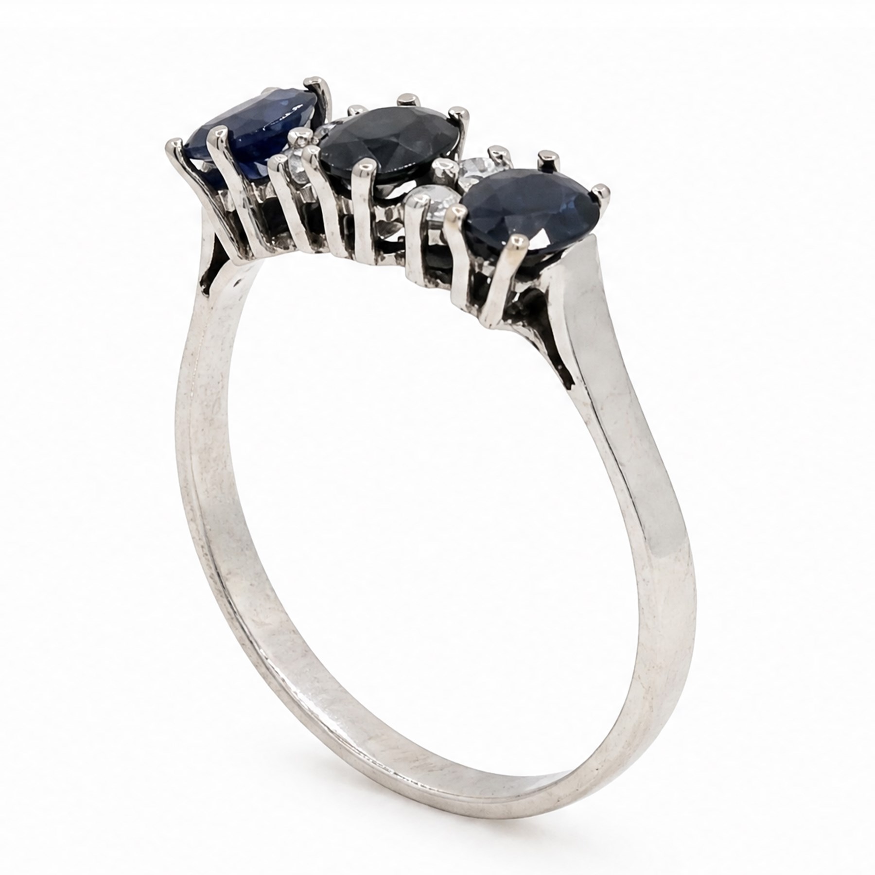 18ct white gold sapphire and diamond ring, three oval cut sapphires spaced by three round brilliant cut diamonds