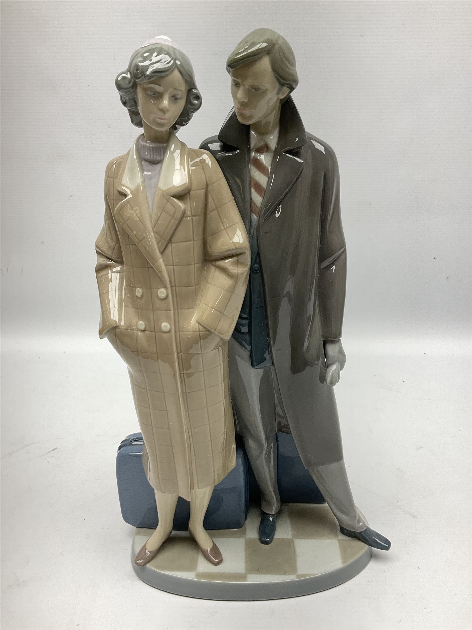 Lladro figure, Sad Parting, modelled as a man and woman with suitcases, sculpted by Francisco Catalá, with original box, no 5583, year issued 1989, year retired 1991, H33cm