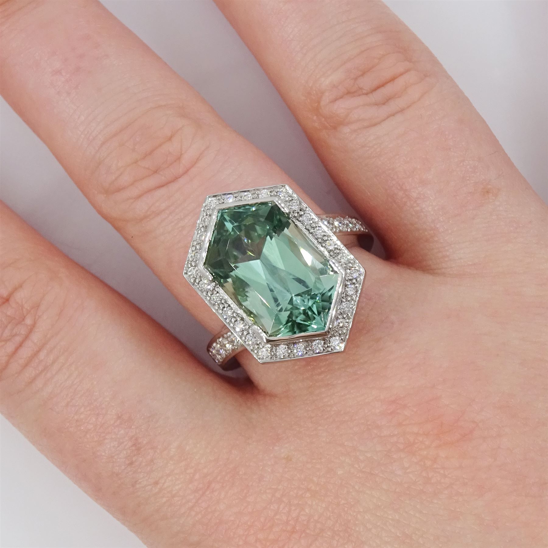Platinum African Paraiba tourmaline and diamond ring by Scarab London, single fancy double bullet cut tourmaline of approx 8.37 carat, with round brilliant cut diamond surround and diamond set shoulders, London 2023, total diamond weight approx 1.05 carat, with Alan Poultney Gems report