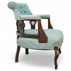 Late Victorian mahogany upholstered tub chair, curved button-back with rope-edge trim over open shaped arms and pierced splat supports, rounded seat upholstered in patterned blue fabric, raised on cabriole front supports