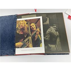 Status Quo: The Official 40th Anniversary Limited Edition book No.926/3000 with certificate signed by Rossi and Parfitt. Duplicate signatures by Rossi and Parfitt on pages within the book. Denim dustjacket; 'From The Makers Of ....' boxed set of three LP records in circular blue tin; and quantity of tour carrier bags