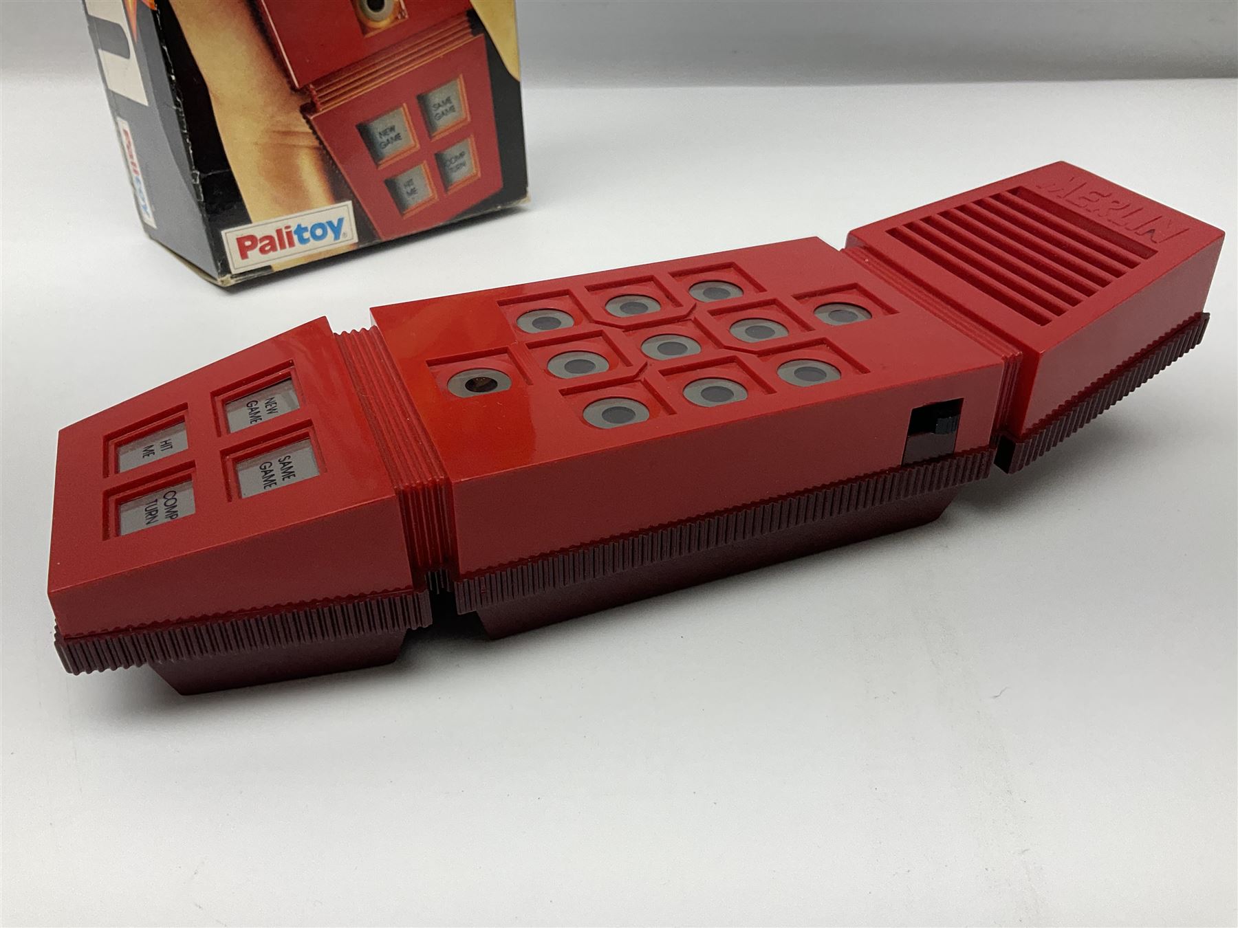 Three late 70s/early 80s handheld electronic games; Bandai Electronics Arcade ‘Gunfighter’ (1980), Grandstand ‘Invader From Space’ (1980), Palitoy ‘Merlin The Electronic Game Machine’ (1979) with game sheet and instruction booklet, all with original boxes (3) 