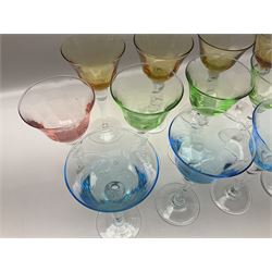 Ten coloured Adriana wine glasses by Abigails, to include blue, green, pink and yellow examples, each with part faceted bowl and twist stems, together with two similar orange examples with pulled stems, H24cm