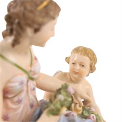 Karl Ens of Volkstedt figure group, modelled as a woman and cherub in a garden, with printed mark beneath, together with another figure modelled as a muse 