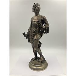 20th century silver plated figure, modelled as a classical male figure, possibly Prometheus, holding flames, one foot resting atop a small dragon, upon a circular spreading base, overall H37.5cm