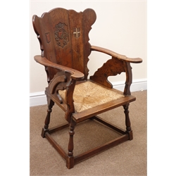  Early 20th century oak chair, carved crests on the splat, drop in rush seat, turned out splayed supports joined by square stretchers, W57cm   