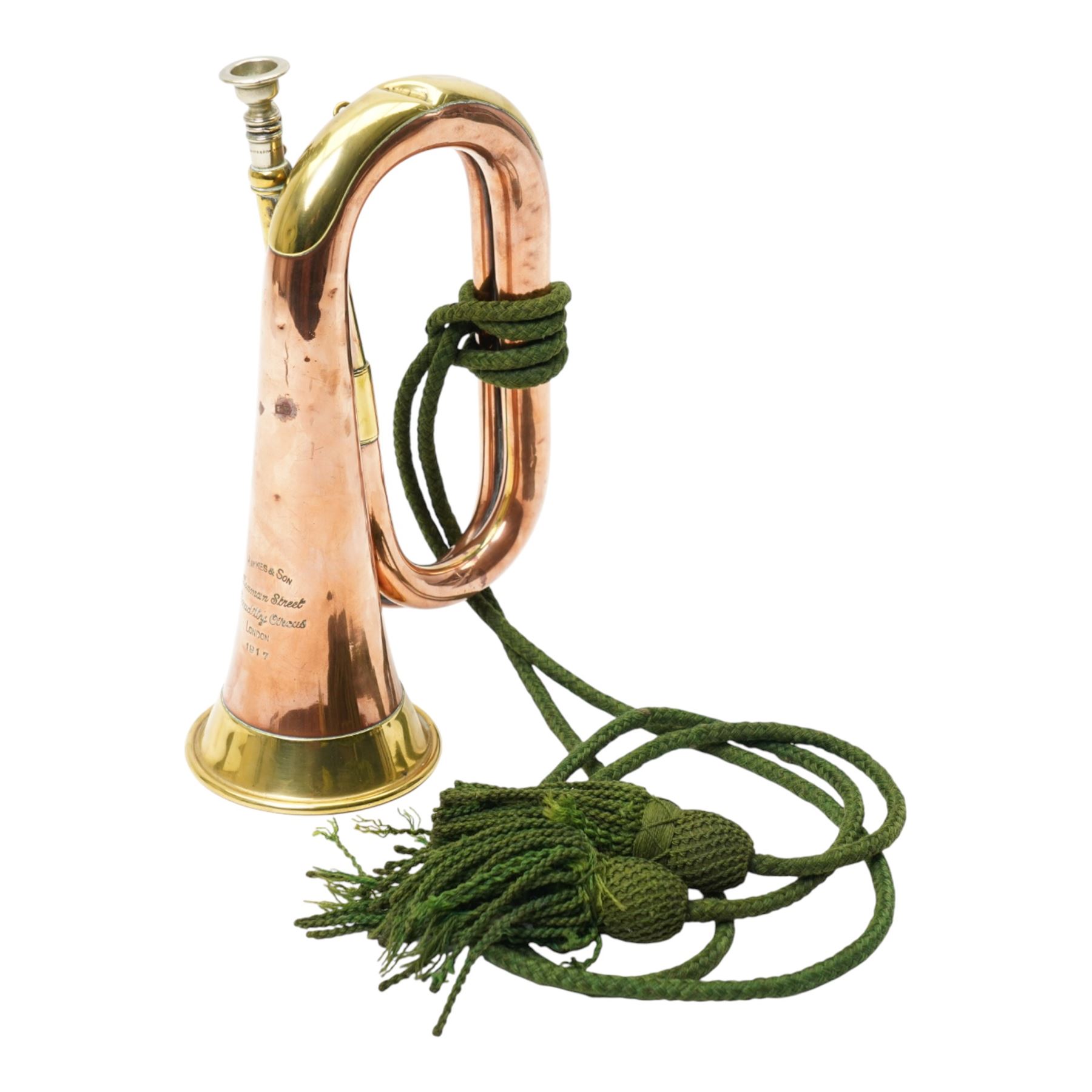 Copper and brass bugle, by Hawkes & Son London, marked to lower body and dated 1917, with green bugle cord