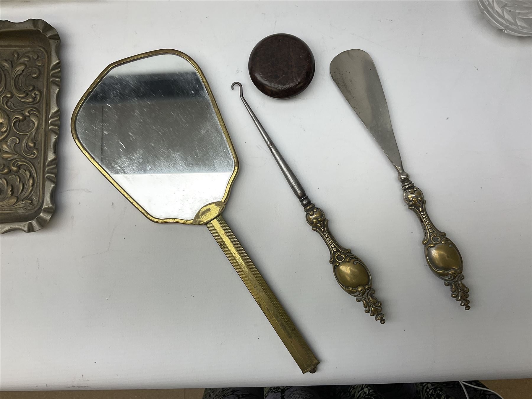 Glass dressing table tray, scent bottles and lidded bowl, metal mounted foliate design hair brushes and handheld mirrors etc