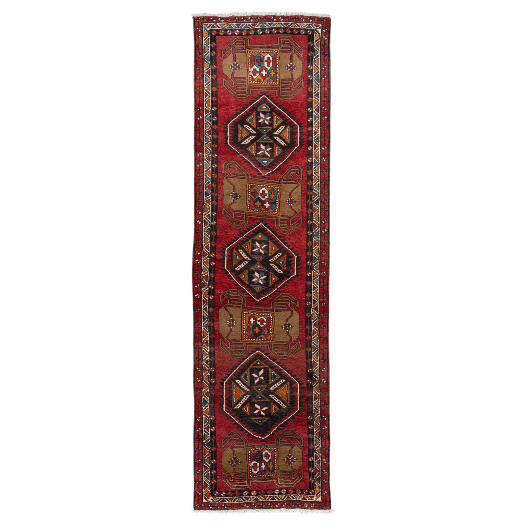 North East Persian Kurdie runner, the red field decorated with three serrated diamond medallions alternating with four ochre hooked motifs enclosing polychrome cruciform panels, within multiple geometric borders of repeating triangles and diamond devices