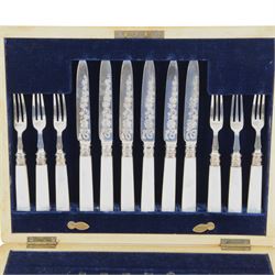 Set of twelve mother of pearl handled silver fruit knives and forks, the knives with floral engraving to blades, hallmarked to both collars and blades/prongs, Frederick C Asman & Co, Sheffield 1906, contained within fitted wooden case with velvet lined interior