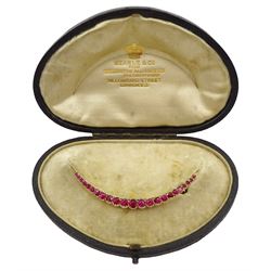 Early 20th century 9ct gold synthetic ruby crescent brooch, in fitted silk and velvet lined box by Searle & Co, London