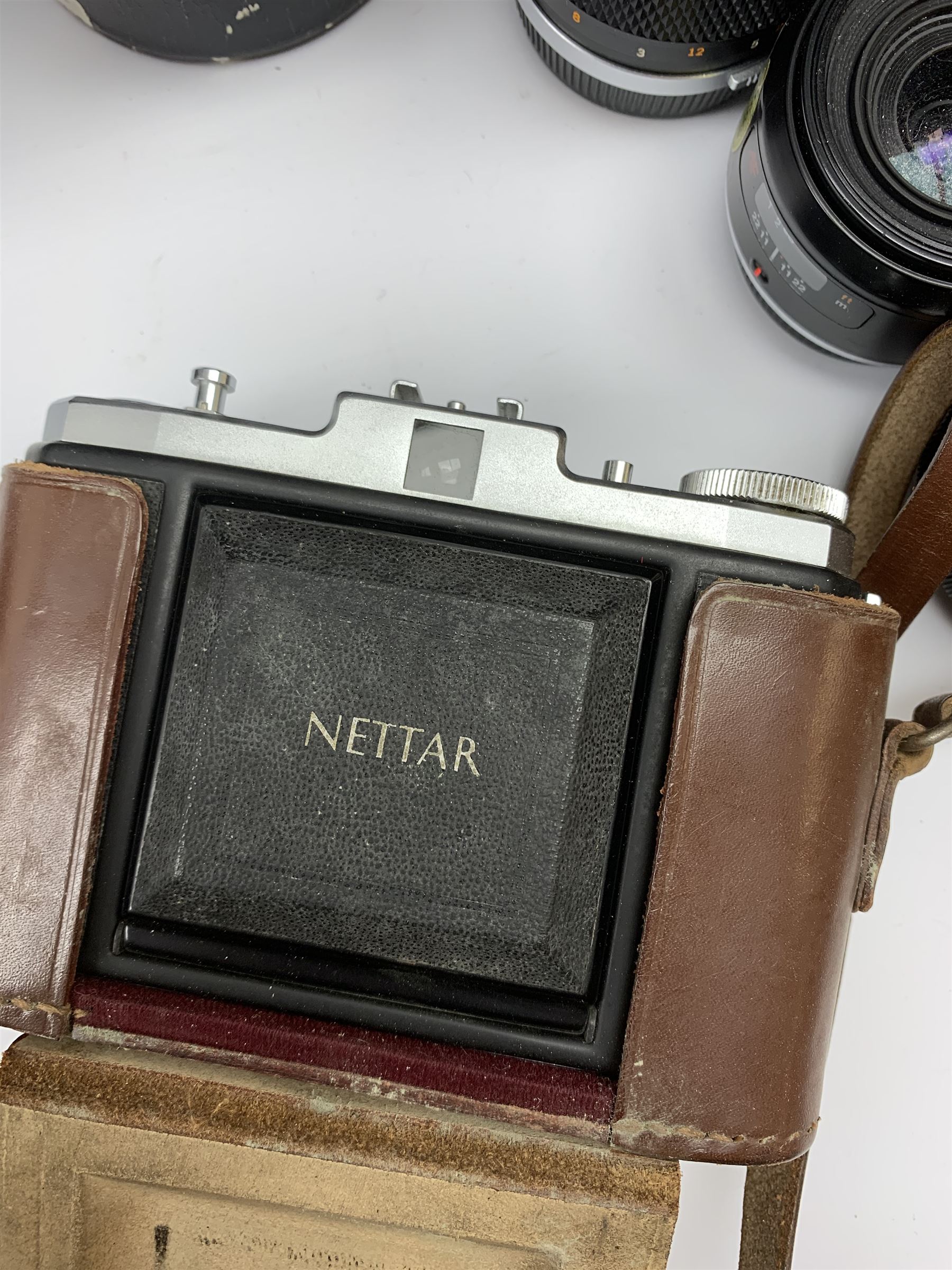 Vintage cameras lenses and accessories including Olympus 'OM10' camera body, Olympus 'OM4' camera, 'Olympus OM-System Zuiko auto-zoom 35-70mm 1:4' lens, various other lenses, tasco binoculars etc, in one box