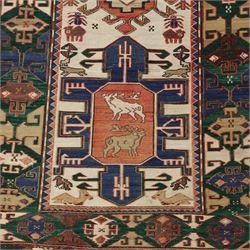 Caucasian Soumak flatweave rug, ivory field with a bold central geometric medallion framed by stylized animal motifs and angular tribal devices, one end of fringe cut, 88x70cm 