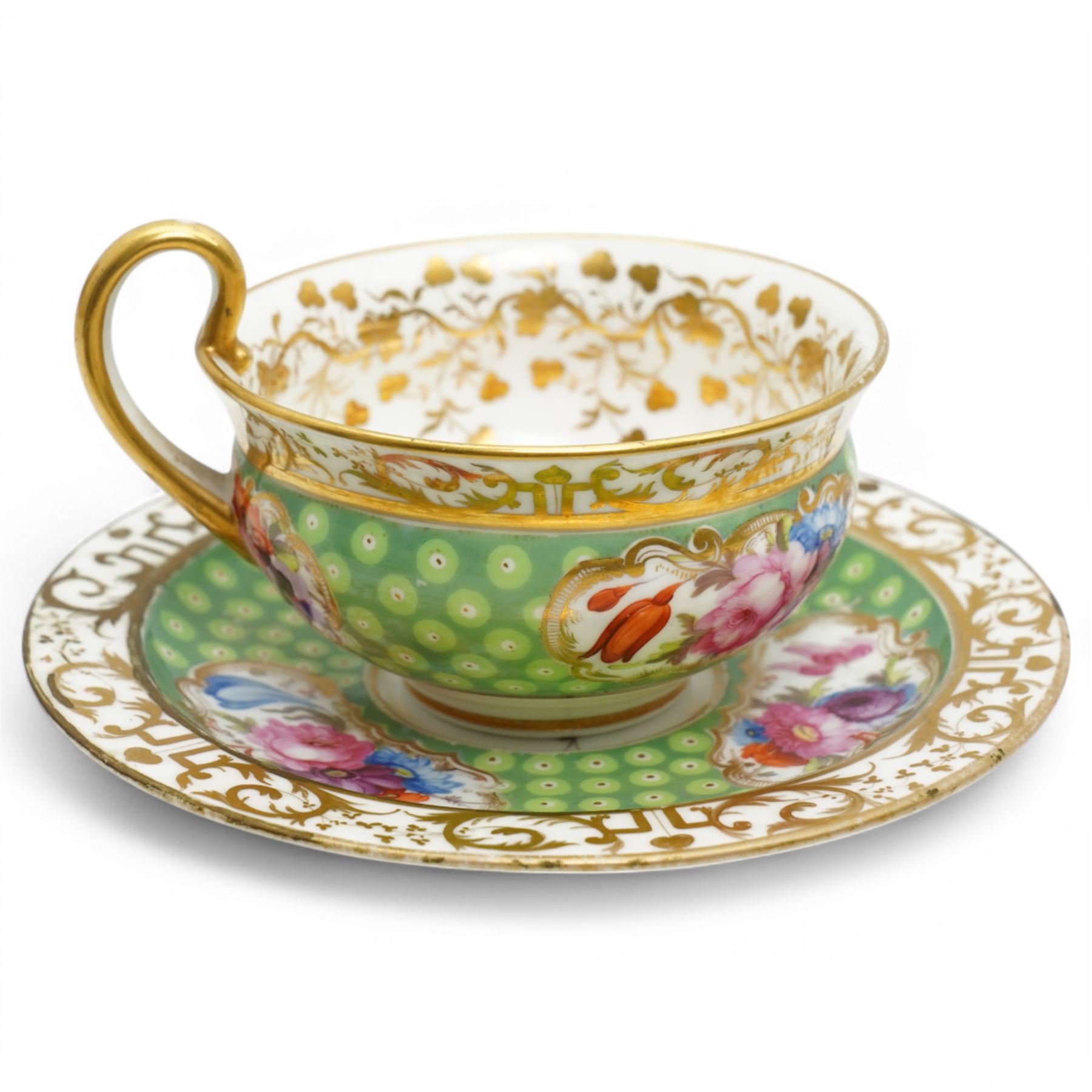  19th century Coalport Felt Spar porcelain cup and saucer painted with panels of flowers on a green and gilt ground and marked I Rose & Co and an early 19th century Worcester trio decorated in blue and gilt, Pattern No.274 