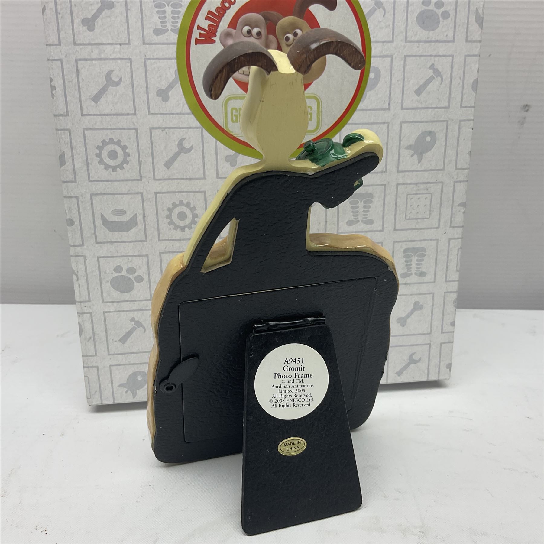 Border Fine Arts Shaun The Sheep Tractor Train and musical figure, together with a Wallace and Gromit photograph frame and a Gromit cruet sett, three in original boxes  
