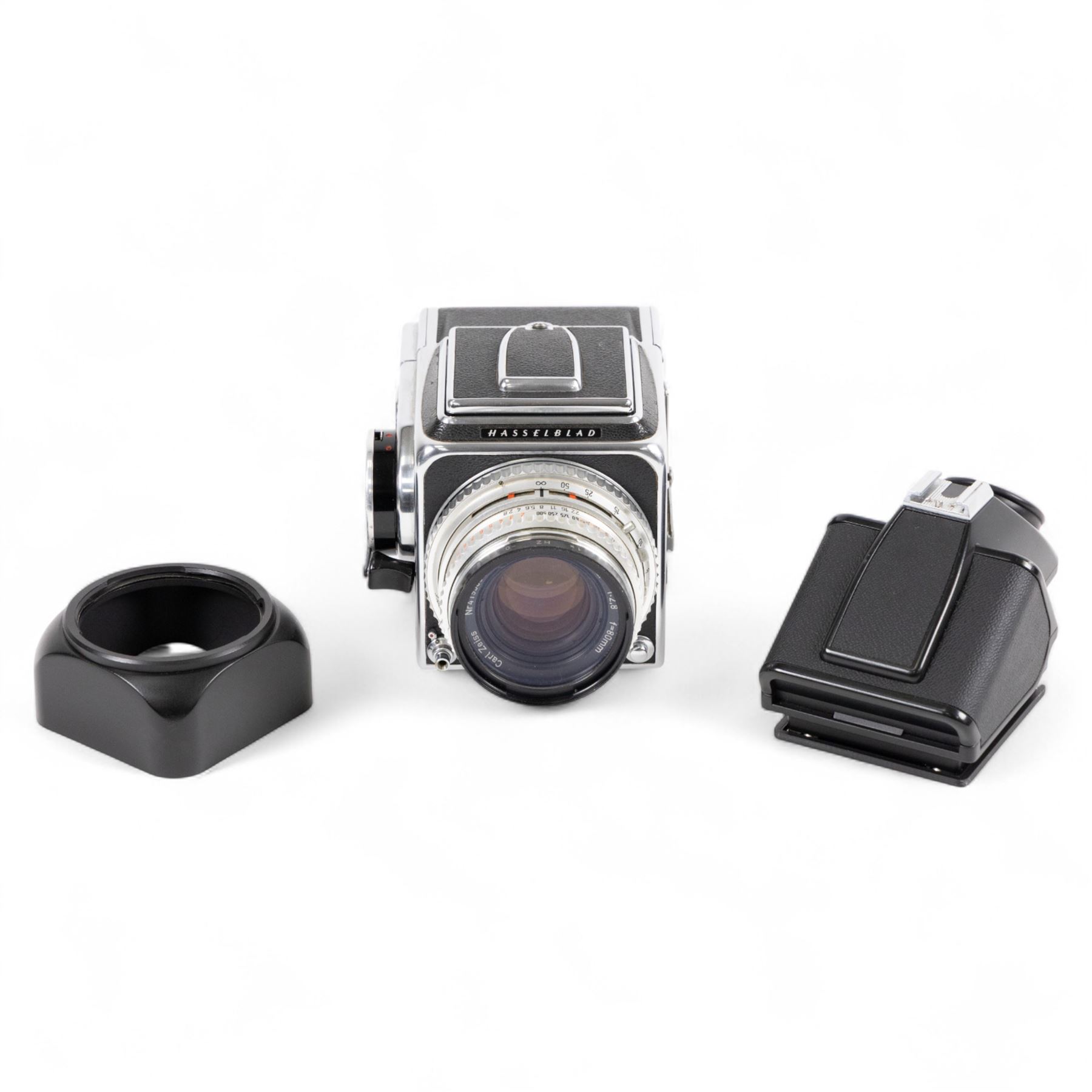 Hasselblad 500C medium format camera, serial no. TC60836, circa 1965, with Carl Zeiss Planar 1:2.8 f=80mm lens with cap, serial no. 4199654, one film back, serial no. TC87300 and a Hasselblad PM5 prism viewfinder serial no. 401EE1335
