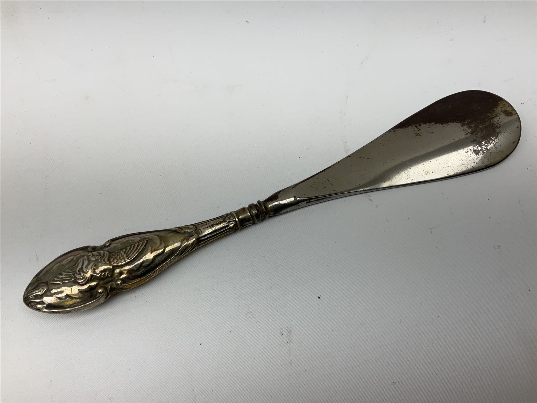 Set of six silver handled butter knives, and a silver handled shoehorn, all hallmarked, but hallmarks worn and indistinct