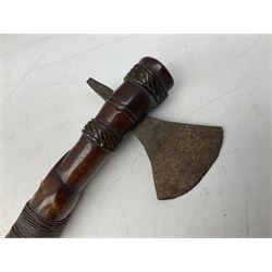 Tribal Art - an African axe, possibly Yoruba, the bone shaft carved as two cord bound stylised figures with iron fan-shaped blade, L35cm overall; and 19th century harpoon or spear head of square section with two long fixing arms on cut-down ash shaft L57cm (2)