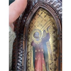 Pair of early 20th century continental painted porcelain religious icon plaques, depicting two angels playing a violin and a sackbut, heightened in gilt, within carved gothic frames, H15cm; together with a camphor wood box with carved decoration, W28cm (3)