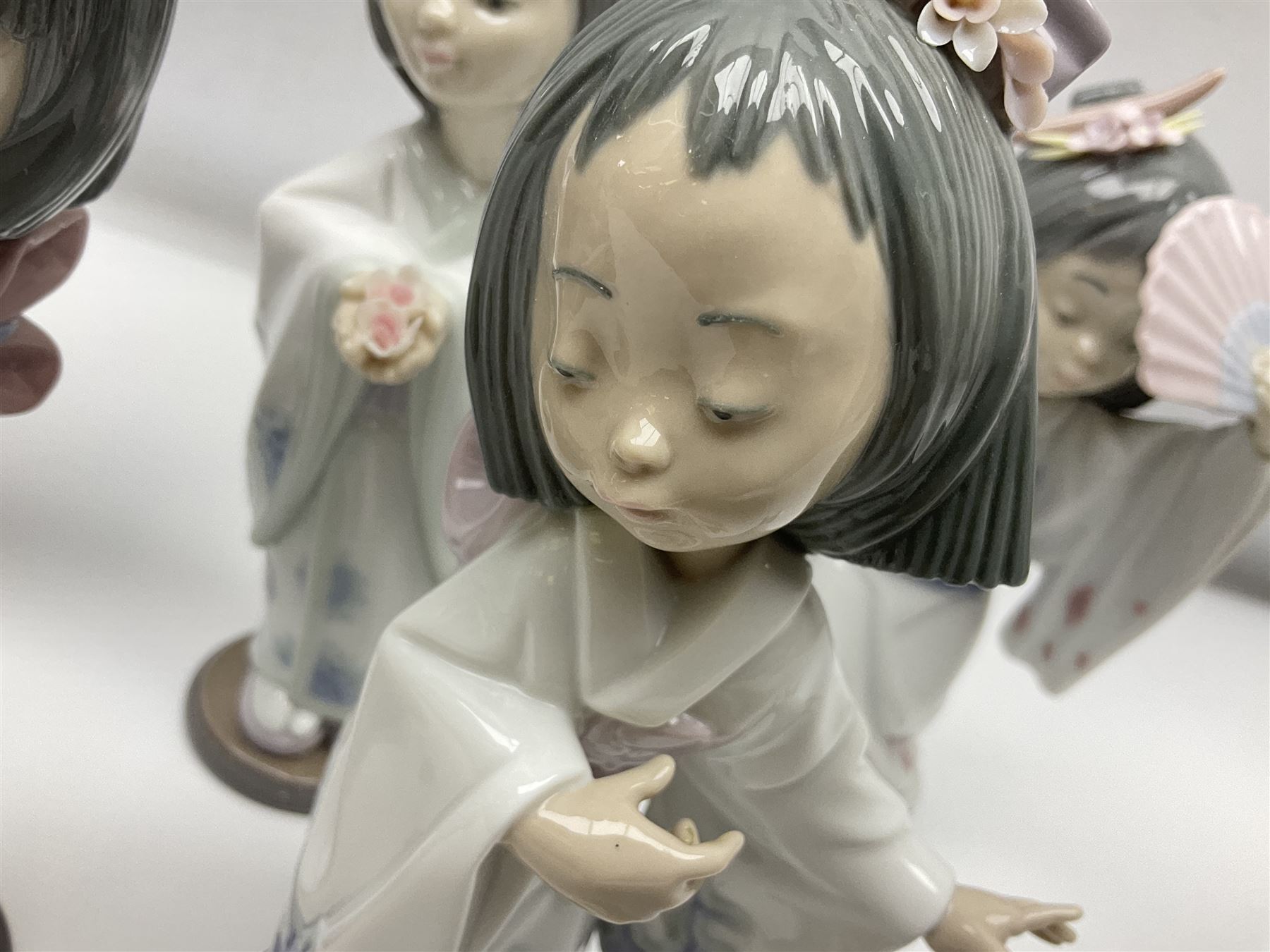 Six Lladro figures of the China doll set and Oriental doll set, comprising Playing the Flute no.6150, Bearing Flowers no.6151, Flower Gazer no. 6152, Oriental Dance no. 6230, Oriental Lantern no. 6231 and Oriental Beauty no. 6232, largest H20cm