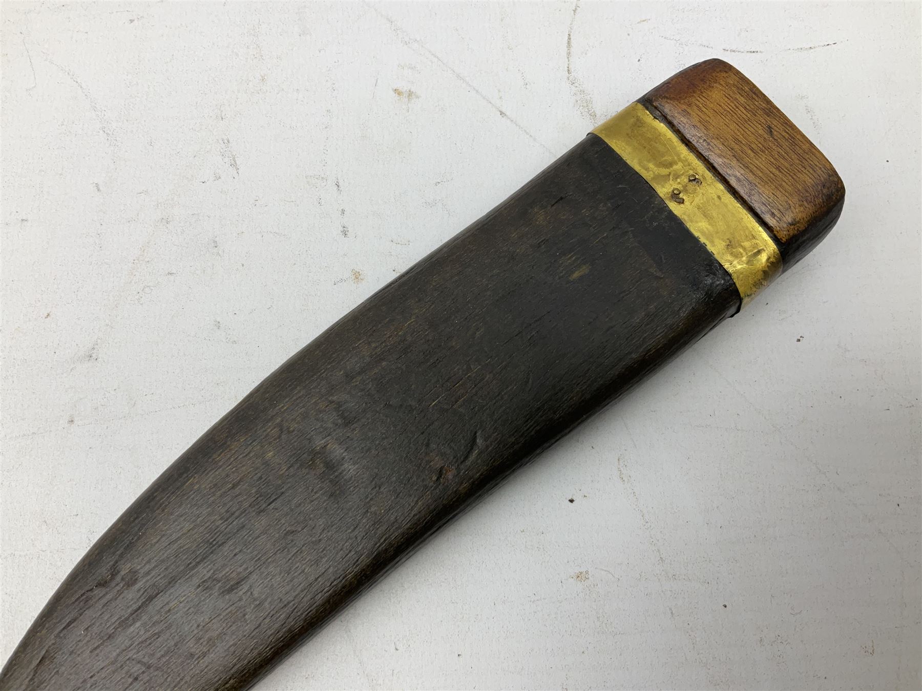 19th century Singhalese knife pia kaetta, the 20cm steel blade inset with yellow and white metal, with metal mounted carved pistol grip, in plain wooden scabbard L33cm overall