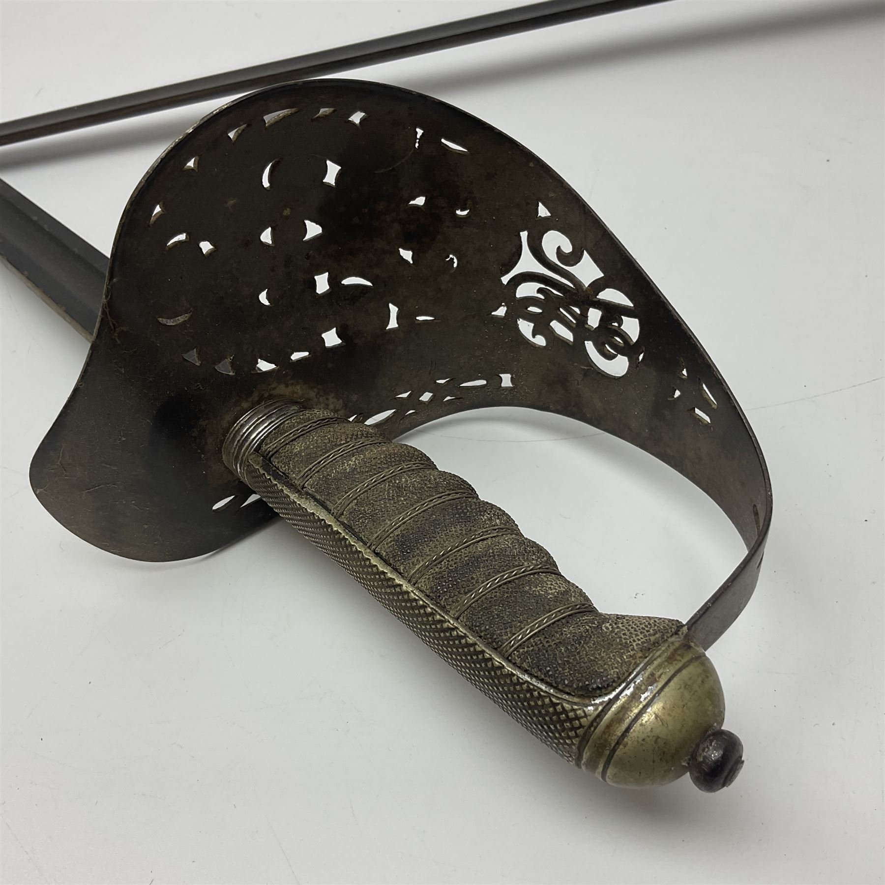 WW1 British Army 1897 Pattern Officers Sword, the 80cm fullered steel blade with traces of decoration and inscribed 'W.E. French 1914'; the basket hilt pierced with the George V cypher and wire-bound fish-skin grip L97cm overall; and WW1 British 1821 pattern Royal Artillery officer's sword with three-bar hilt; both lacking scabbard (2)