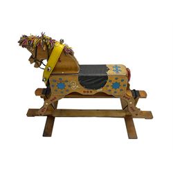 Painted rocking horse on polished pine trestle base
