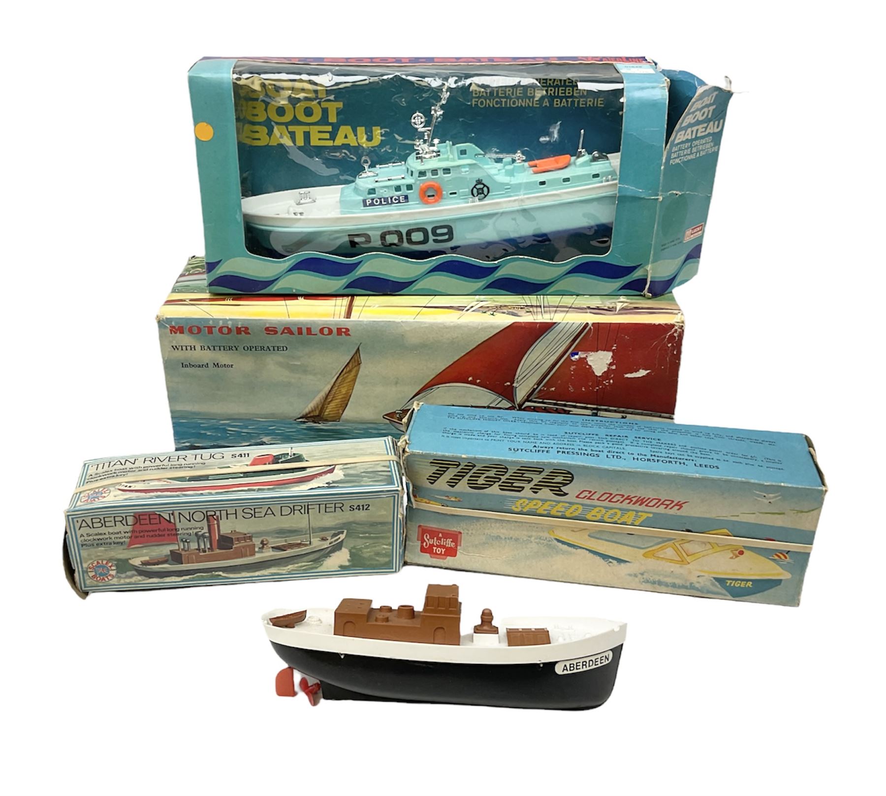 Five model boats - Sutcliffe clockwork Tiger Speedboat; boxed; Motor Sailor battery operated yacht; boxed; Waterline battery operated police launch; boxed; and Tri-ang Scalex 'Aberdeen' North Sea Drifter; boxed, with another similar unboxed (5)