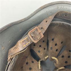 WW2 German Infantry M40 steel helmet with tropical finish and traces of single decal; with chin strap and leather liner marked 57 twice in red; back apron stamped 11 38