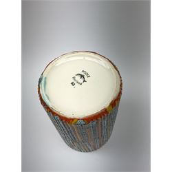 A Poole Pottery Delphis vase, shape 83, with textured effect in merging tones of red, yellow and blue, with printed mark beneath, H15cm.