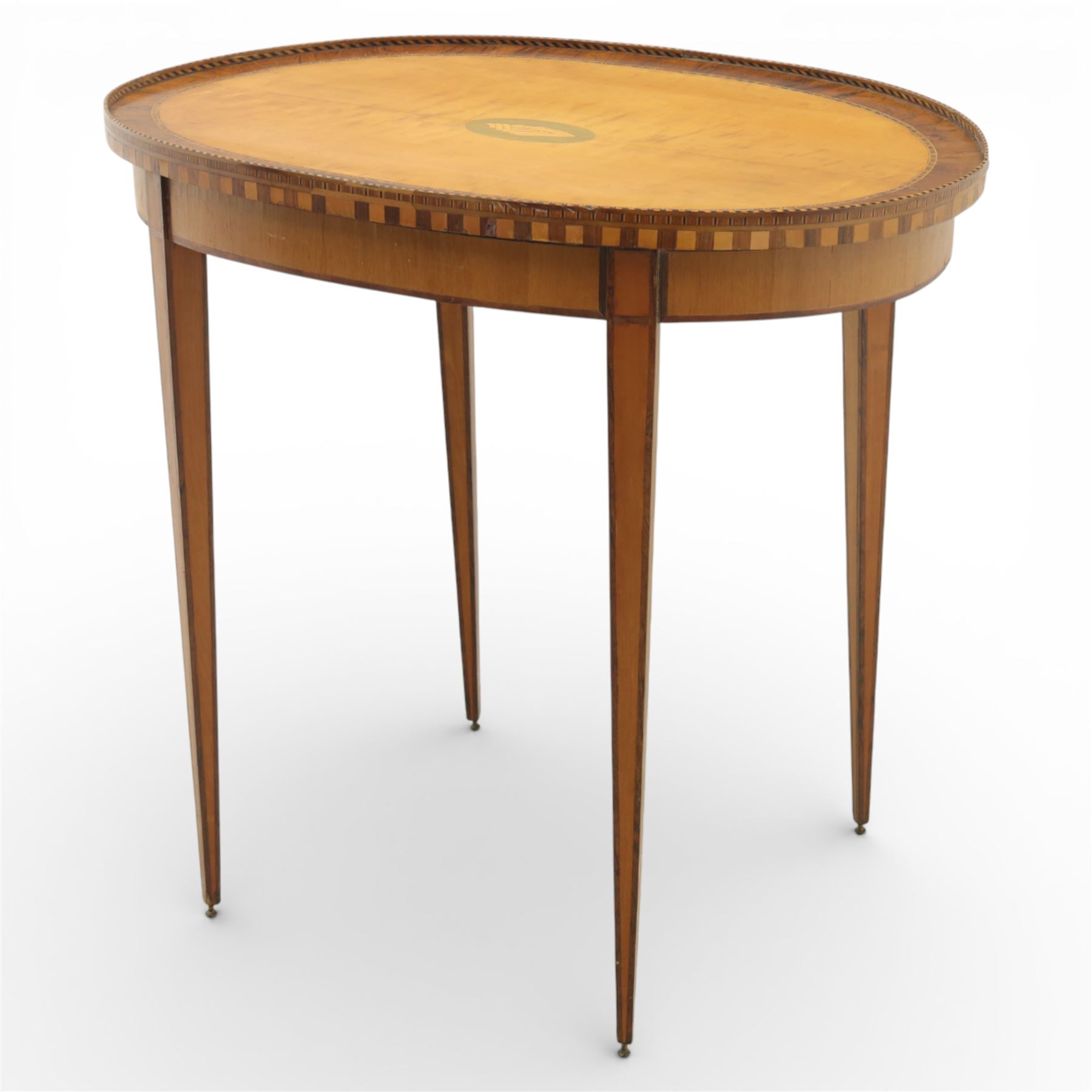 Early 19th century Sheraton revival satinwood oval table, shell motif to the centre bordered by walnut veneer, with inlaid banding, supported on square tapering legs terminating in brass feet