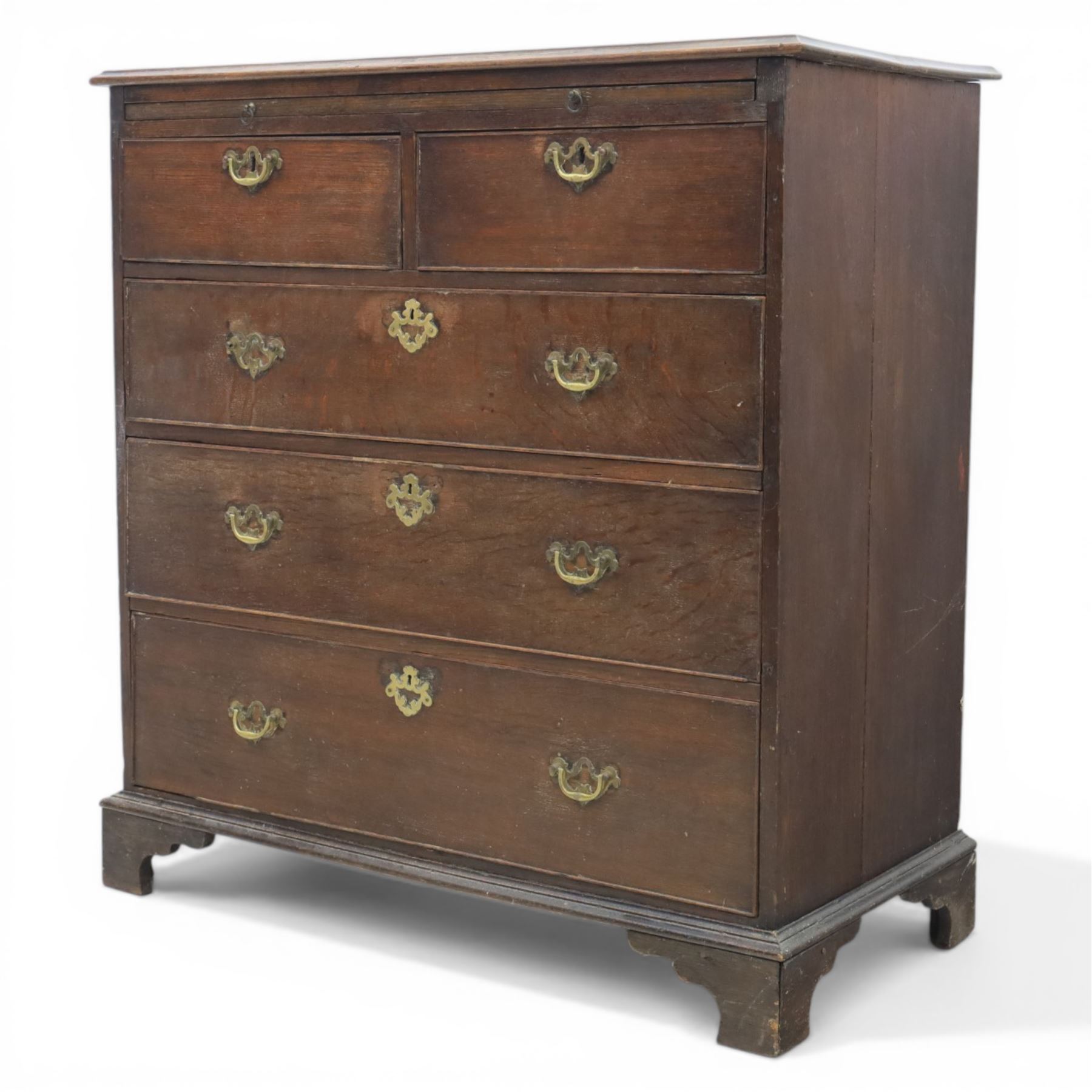 18th century oak chest, rectangular top with moulded edge, fitted with five drawers and baize line slide, with swan neck brass handles, raised on bracket feet