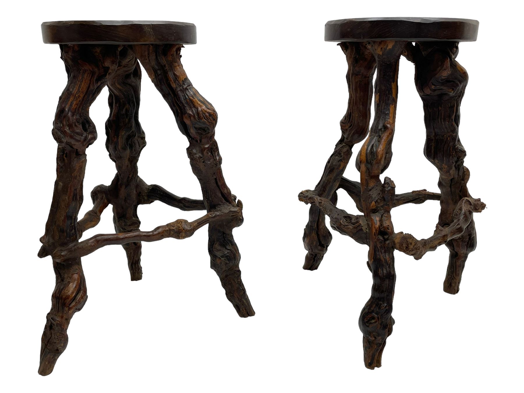 Mid-20th century French grapevine and walnut bow-front wine tasting bar, the curved counter top supported by sculptural grapevine roots, fitted with single shelf and raised on rustic vine feet (W100cm H101cm); with a pair of matching bar stools, the circular top raised on three gnarled root supports united by stretchers (W50cm H70cm)