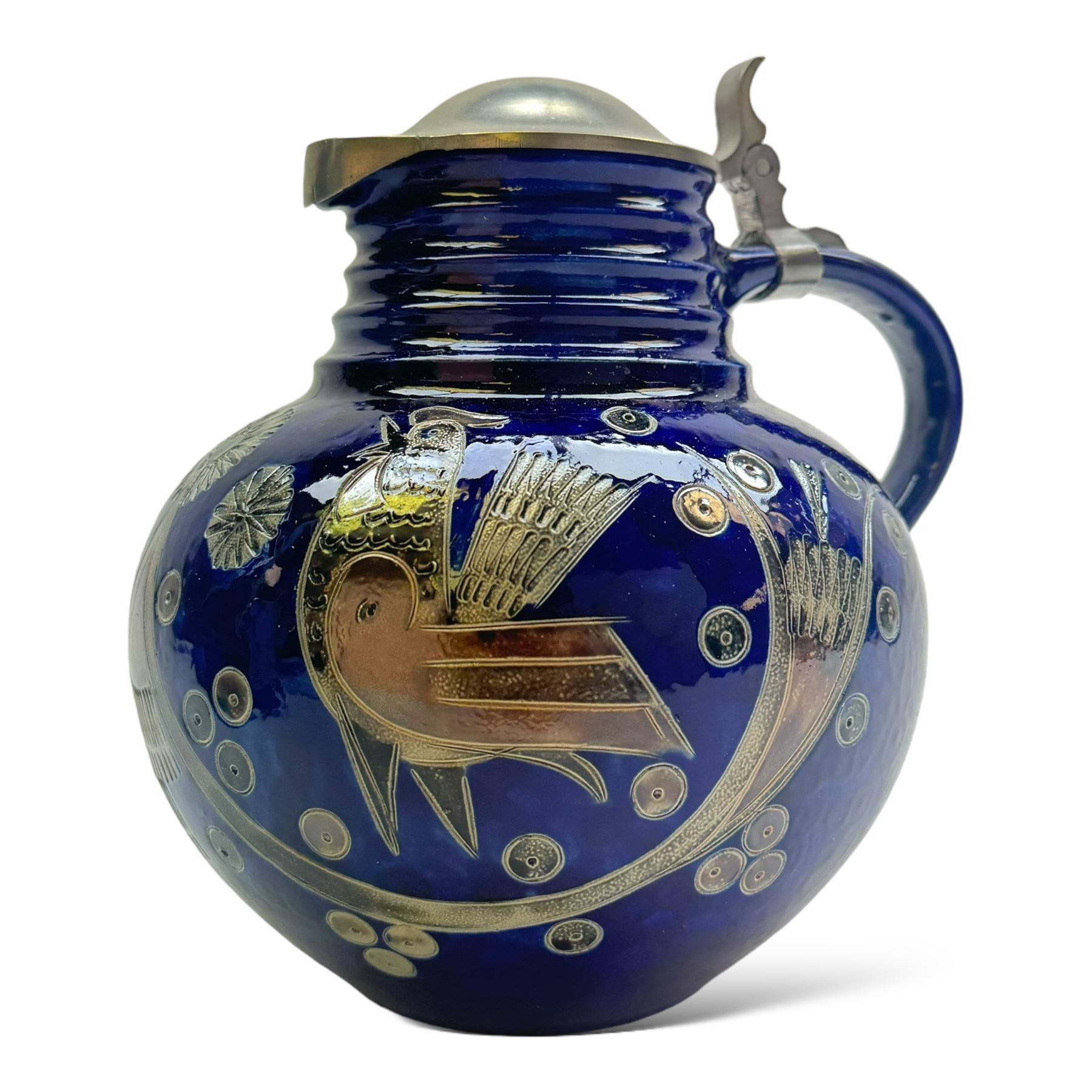 Wim Muhlendyck (1905-1986),  saltglaze stoneware jug of globular form with pulled and applied handle and ribbed neck with white cover, with stylised cockerels and flowers on a dark blue ground, with makers mark beneath, H22cm