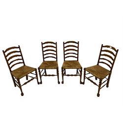 Four oak ladder back chairs with rush seats