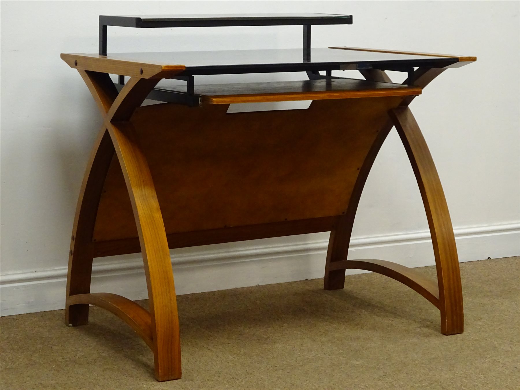 Contemporary walnut finish bent plywood desk with black glass top and