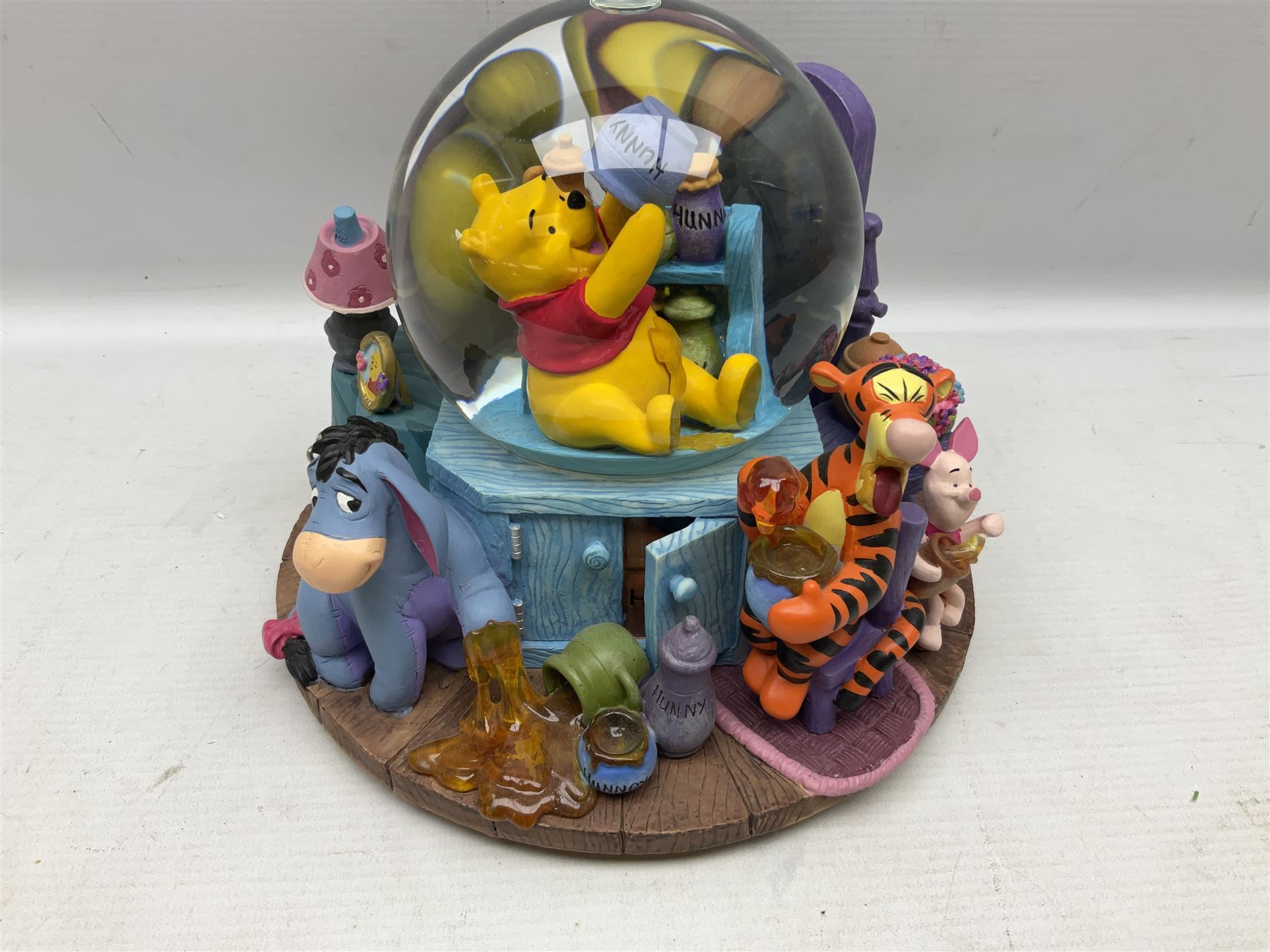 Five Disney Winnie The Pooh snow globes, to include Pooh and Piglet Sailing, Pooh's Grand Adventure and Blustery Day, together with The Walt Disney Classic Waterglobe collection globe and group Tigger, Winnie and Piglet figure under dome, all with boxes (7)