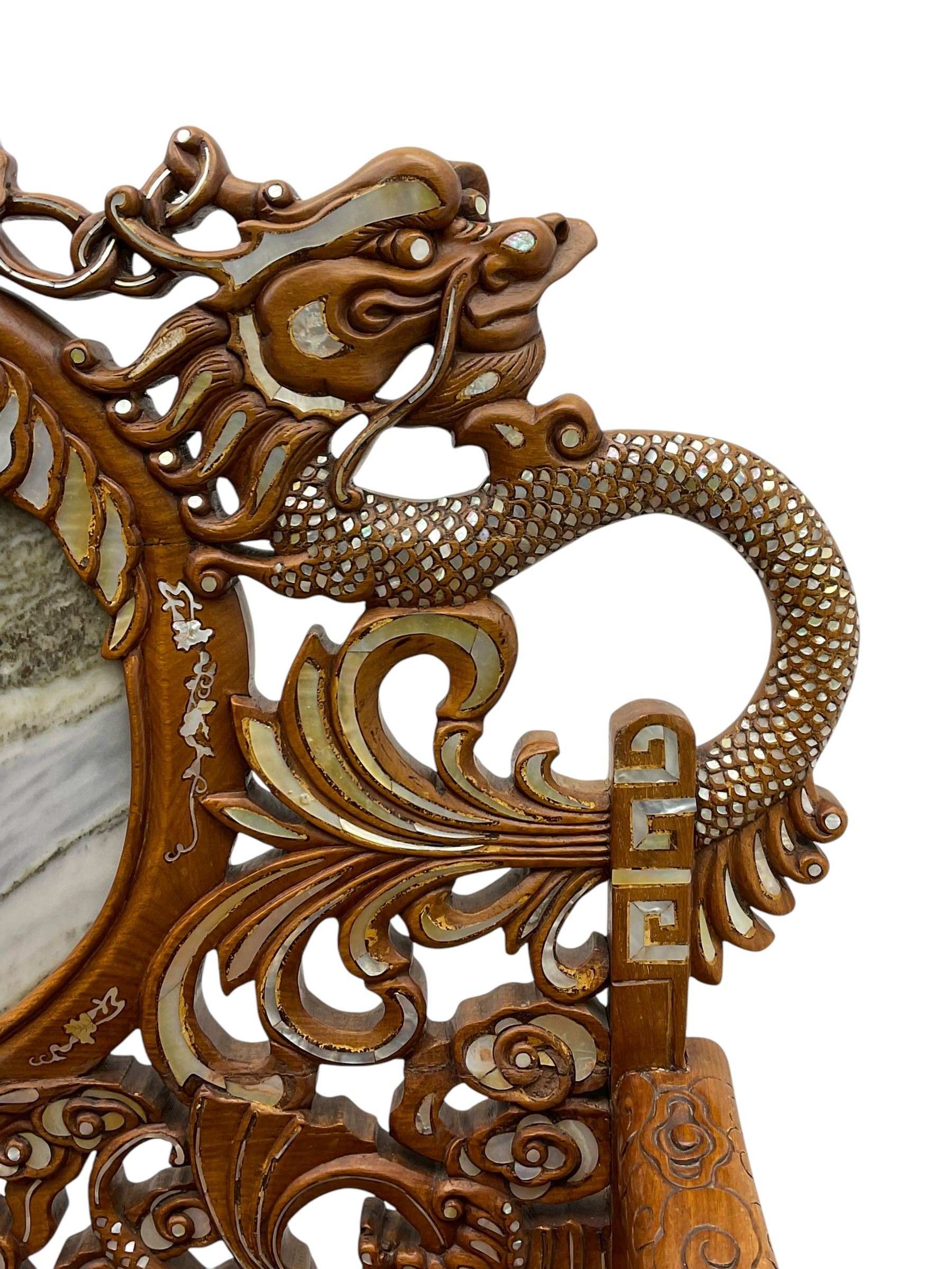 Chinese hardwood three-seat sofa, shaped back inset with three grey marble panels, decorated with carved dragons and birds with flower heads, inlaid with mother of pearl, the seat panel decorated with trailing foliage, flowers and birds inlay, on ball and claw carved cabriole feet united by stretchers